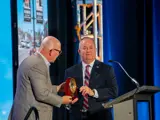 Dr. Tracy Farnsworth receiving the Legacy Award from Mayor Robert Simison 